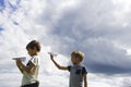 Little boys with paper planes against blue sky Royalty Free Stock Photo