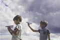 Little boys with paper planes against blue sky Royalty Free Stock Photo