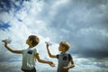 Little boys with paper planes against blue sky Royalty Free Stock Photo