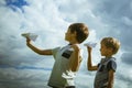 Little boys with paper planes against blue sky Royalty Free Stock Photo