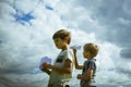 Little boys with paper planes against blue sky Royalty Free Stock Photo