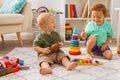 The little boys play with musical toys in kindergarten