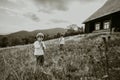 Little boys playing on flutes - ukrainian sopilka on meadow Carpathian mountain