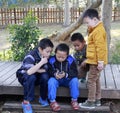 Little boys playing a new phone