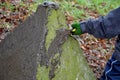 Little boys playing on throwing walls with mud cement plaster. they borrowed tools from dad. spatulas smear mud like tile adhesive