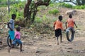 Little boys playing with the wheels on the street in Africa Royalty Free Stock Photo