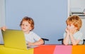 Little boys pupils with happy face expression near laptop, school concept. Kids with a notebook. Portrait of clever