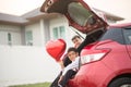 Little boys sitting on the back door of the car with balloon heart hand Royalty Free Stock Photo