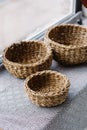 Little braided baskets of natural vines on the sub-house near the window. Eco storage concept