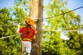 Little brave caucasian girl treerunner fasten the rollclip before climbing