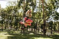 Little brave girl on zipline in rope park