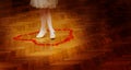 Little bridesmaid girl legs in white dress on wedding dancefloor with rose petals. Royalty Free Stock Photo