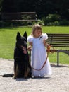 A little bridesmaid and her dog. Royalty Free Stock Photo