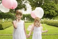 Little Bridesmaids Holding Balloons In Garden Royalty Free Stock Photo