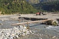 Little bridge through mountain river in Nepal Royalty Free Stock Photo