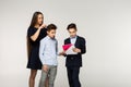 Little brother explains the task, older sister and brother want help him Royalty Free Stock Photo