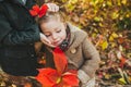 Little brother with love touch face of baby sister. Baby girl with red autumn leaves Royalty Free Stock Photo