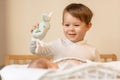 little brother plays with his newborn sister, baby meets newborn at home, two children in family Royalty Free Stock Photo