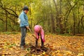 Little brother and sister in autumn park