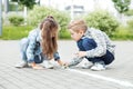 Little brother and sister draw with chalk on the pavement. The concept of childhood, back to school, friendship Royalty Free Stock Photo