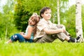 Little brother and sister sitting back to back Royalty Free Stock Photo