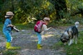 Little brother and sister walk with puppy. Childhood memories. Adventure and vacations children concept. Love kids