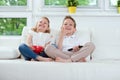 Little brother and sister watching tv on couch Royalty Free Stock Photo