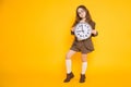 Little brunette girl in costume with clocks