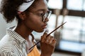 Close up of young talented artist holding little painting brush