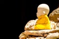 Little buddha statue on the rock Royalty Free Stock Photo