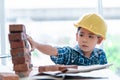 Builder boy is learning how to build brick wall in vintage tone