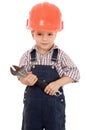 Little builder in coveralls and helmet with wrench