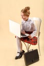 Little business girl write in notepad. Business style clothing, plaid skirt, white blouse. Work at the laptop. Emotional child, Royalty Free Stock Photo