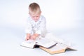 Little business man in solid white suit reads books