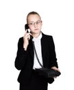 Little business woman talking on a phone, screaming into the phone. Studio portrait of child girl in business style Royalty Free Stock Photo