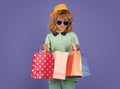 Little buyer customer. Child on shopping. Portrait of child boy with shopping bags. Fashion child in shirt, sunglasses