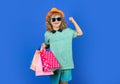 Little buyer customer. Child on shopping. Portrait of child boy with shopping bags. Fashion child in shirt, sunglasses
