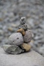 a little cairn in profile of nine grey stacked stones on a stone field, detail of landscape