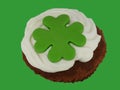 Little cake with cream and green cloverleaf Royalty Free Stock Photo