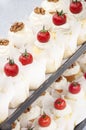 Little cakes decorated with cherry tomatoes and walnuts Royalty Free Stock Photo