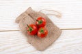 Little sack and red ripe tasty fresh cherry tomatos Royalty Free Stock Photo