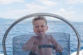 Little captain having fun on boat in the sea