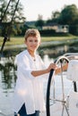 a little captain at the helm on a yacht. a little boy at the helm of the captain on a yacht at sunset