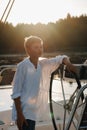 a little captain at the helm on a yacht. a little boy at the helm of the captain on a yacht at sunset