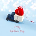 Little car carries a red heart. Concept of Valentine Day. Valentine`s Day card Royalty Free Stock Photo