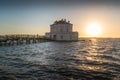 Little Casina Vanvitelliana at sunset with sea sun waves and pedestrian bridge