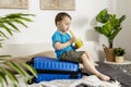 Little caucasian boy with blue shirt ready for vacation. Happy child with blue suitcase going to travel. Tourist, joy of