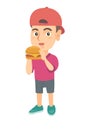 Little caucasian boy eating a hamburger.