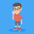 Little caucasian boy holding a lollipop candy. Royalty Free Stock Photo