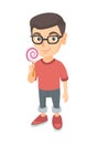 Little caucasian boy holding a lollipop candy. Royalty Free Stock Photo